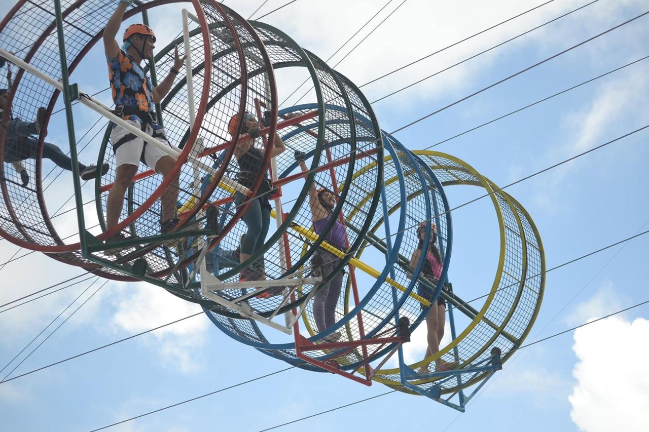 Visitors crossing a suspended tubular obstacle course at Campuestohan Highland Resort