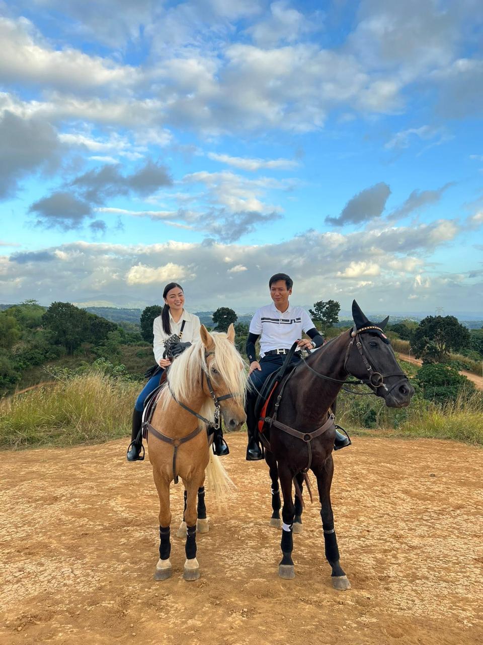 Two visitors on horseback on a grassy trail at UCM Adventure Park