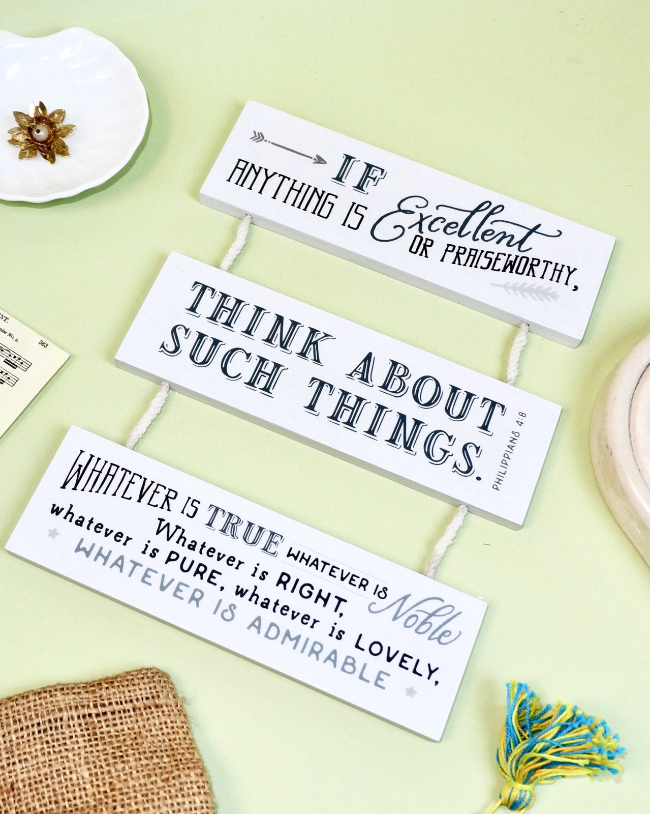 Papemelroti decorative plaques with inspirational quotes on a pale green background