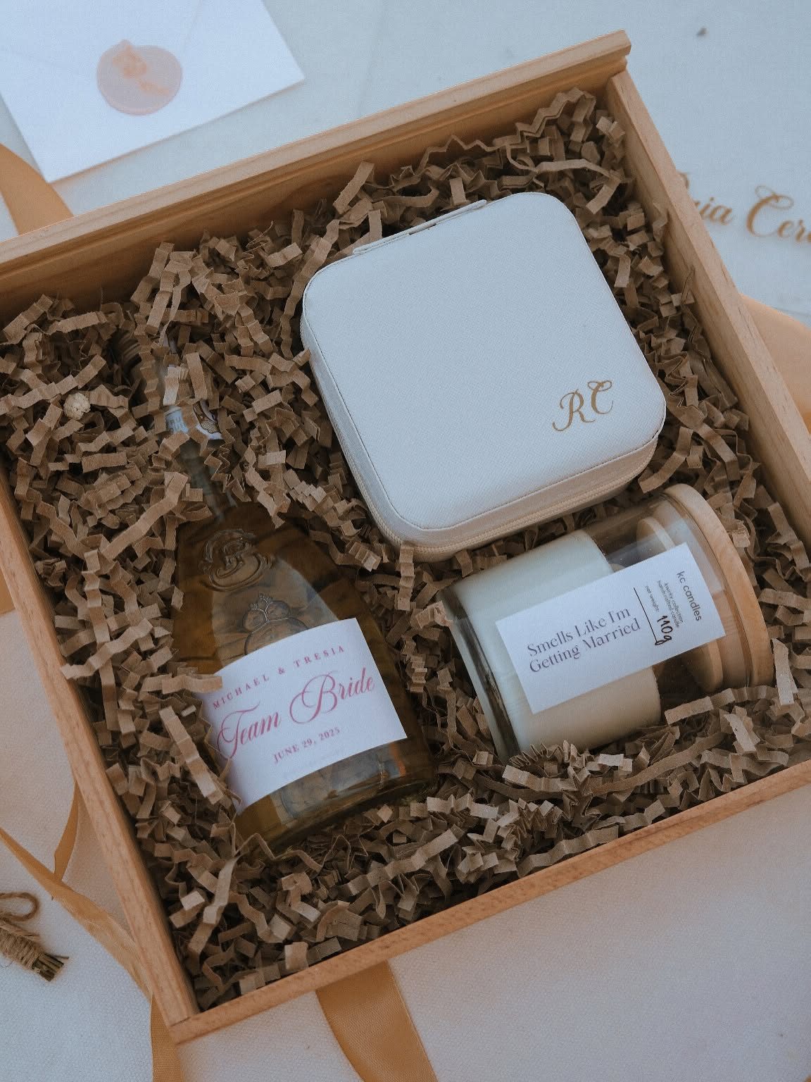 Pensée Gifting Studio gift box with a monogrammed case and small glass jars in shredded-paper filling