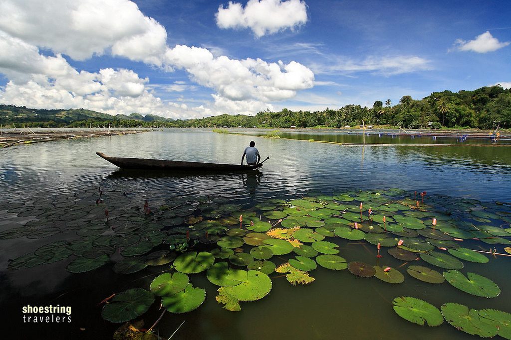 Person in a wooden canoe among water lilies on Lake Sebu in South Cotabato